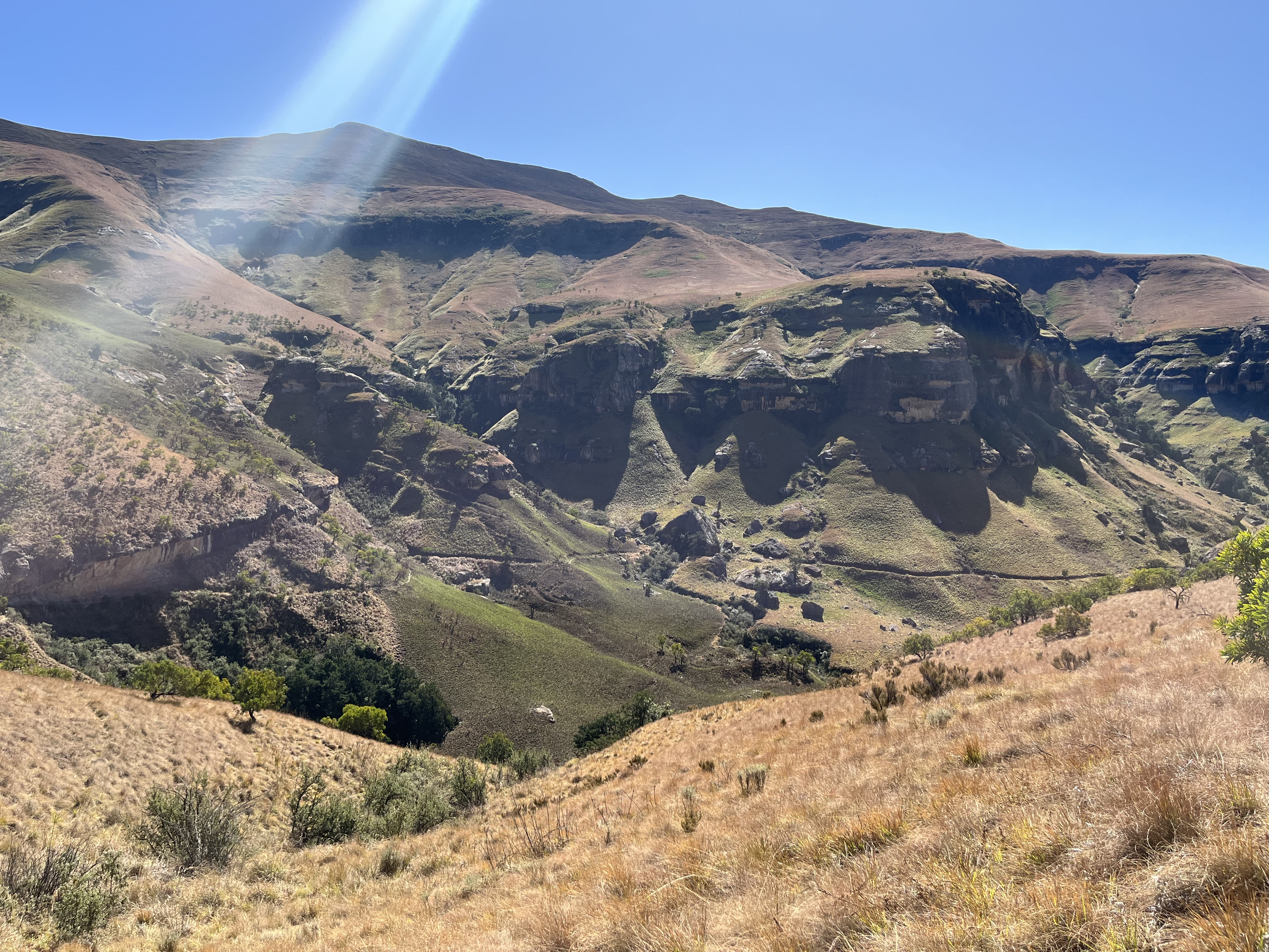 The trail drops down and then continues on the other side of the valley